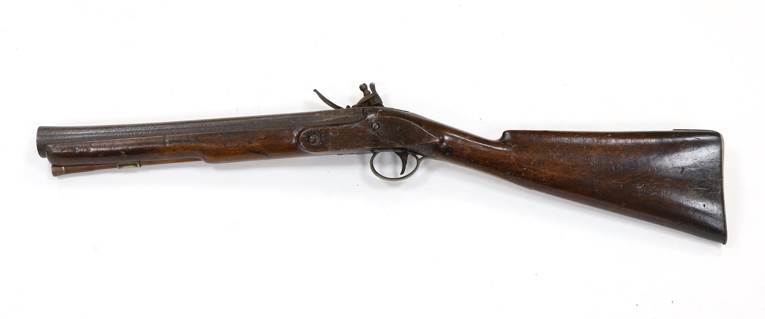 A flintlock blunderbuss fitted with a regulation British military service lock, stamped with tower and crown, GR civilian brass mounts, full stocked with wooden ramrod, barrel 36.5cm